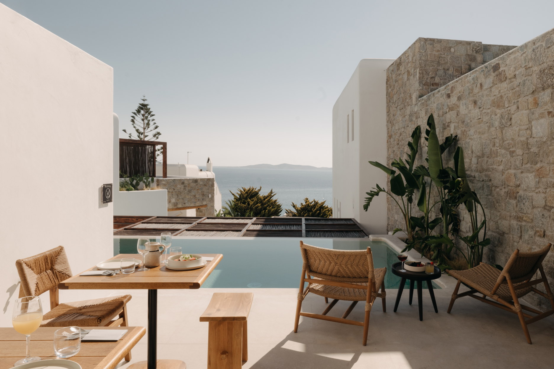 A terrace pool at Bard de Sol surrounded by planting, with the sea beyond