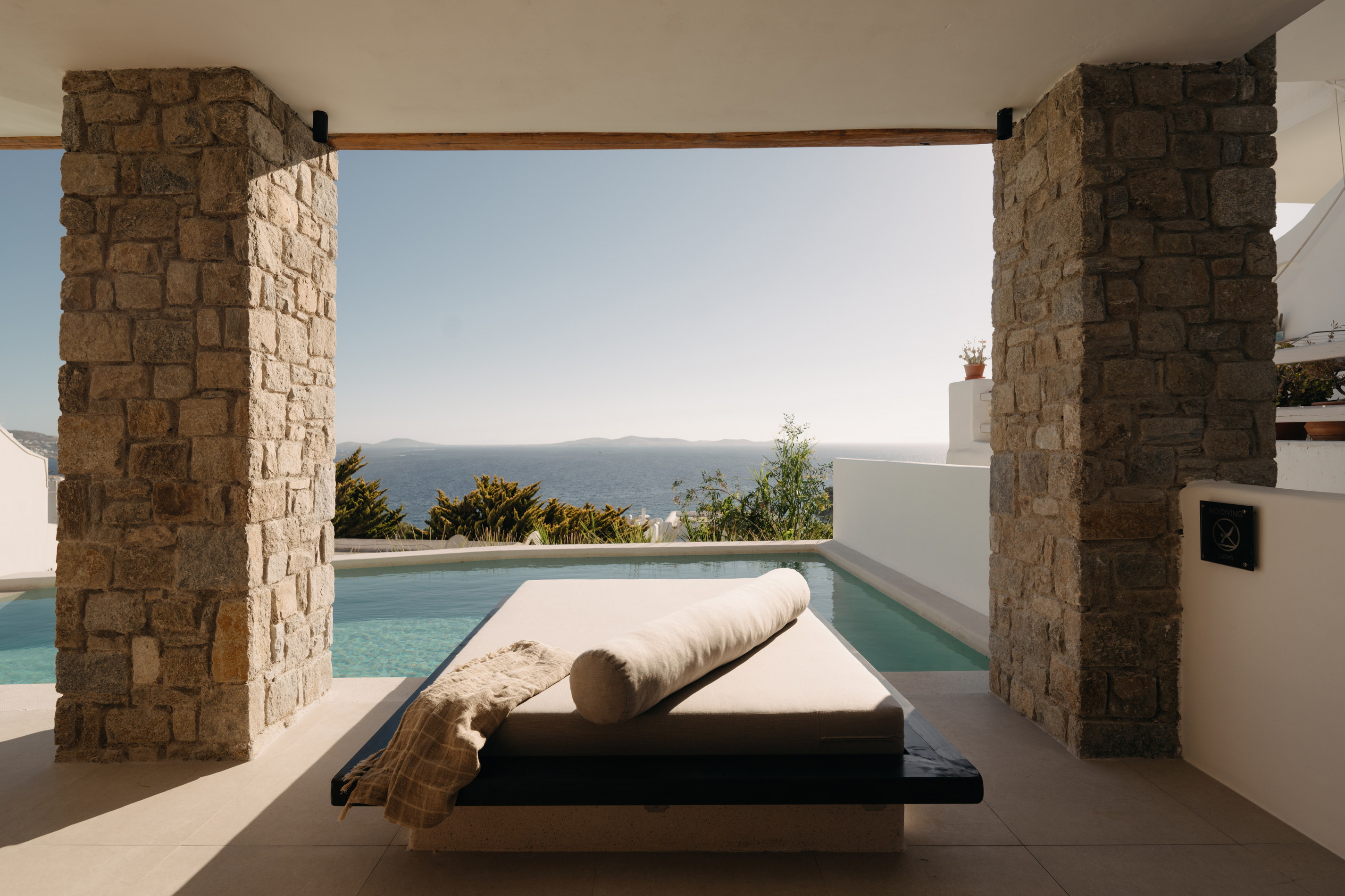 A sun lounger beside a private plunge pool at Bard de Sol, sheltered by a stone wall
