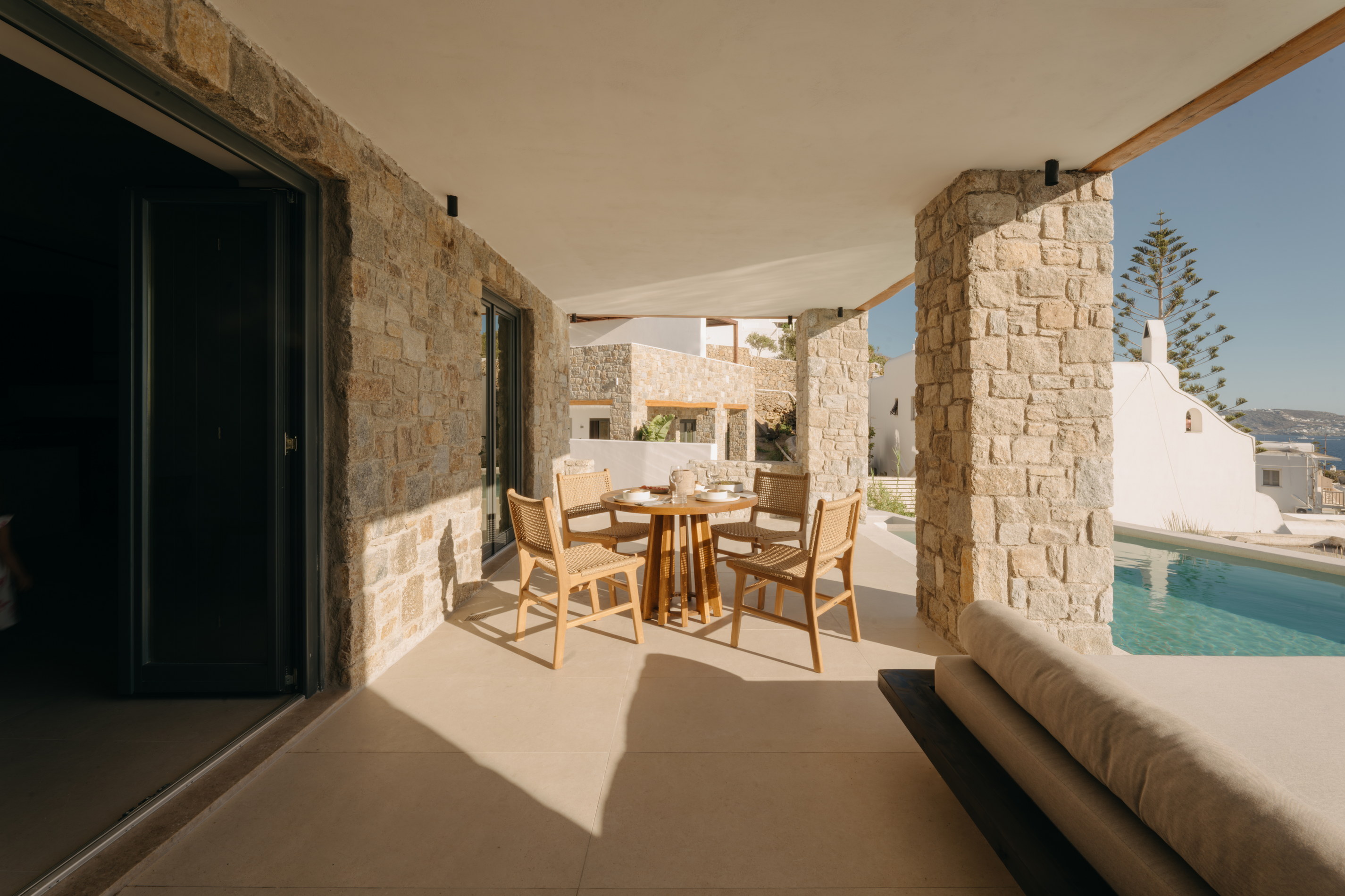 A covered walkway between the stone and whitewashed buildings at Bard de Sol