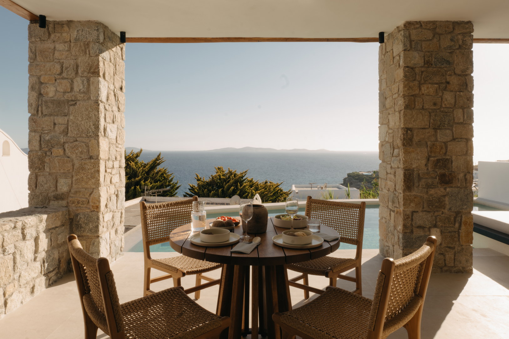 Shaded terrace seating at Bard de Sol looking out over the bay at Agios Stefanos