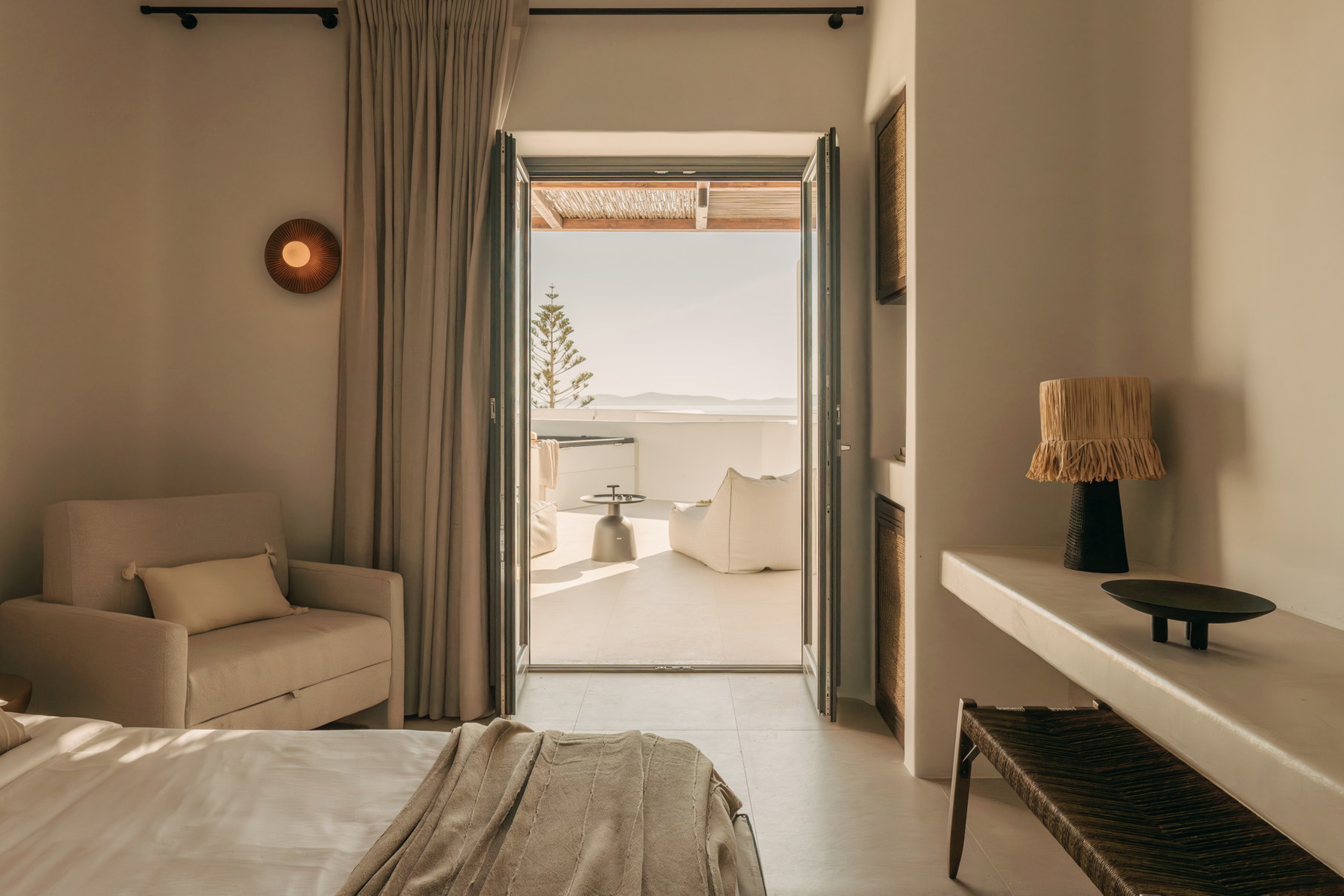 A Bard de Sol suite opening onto its terrace and the water beyond