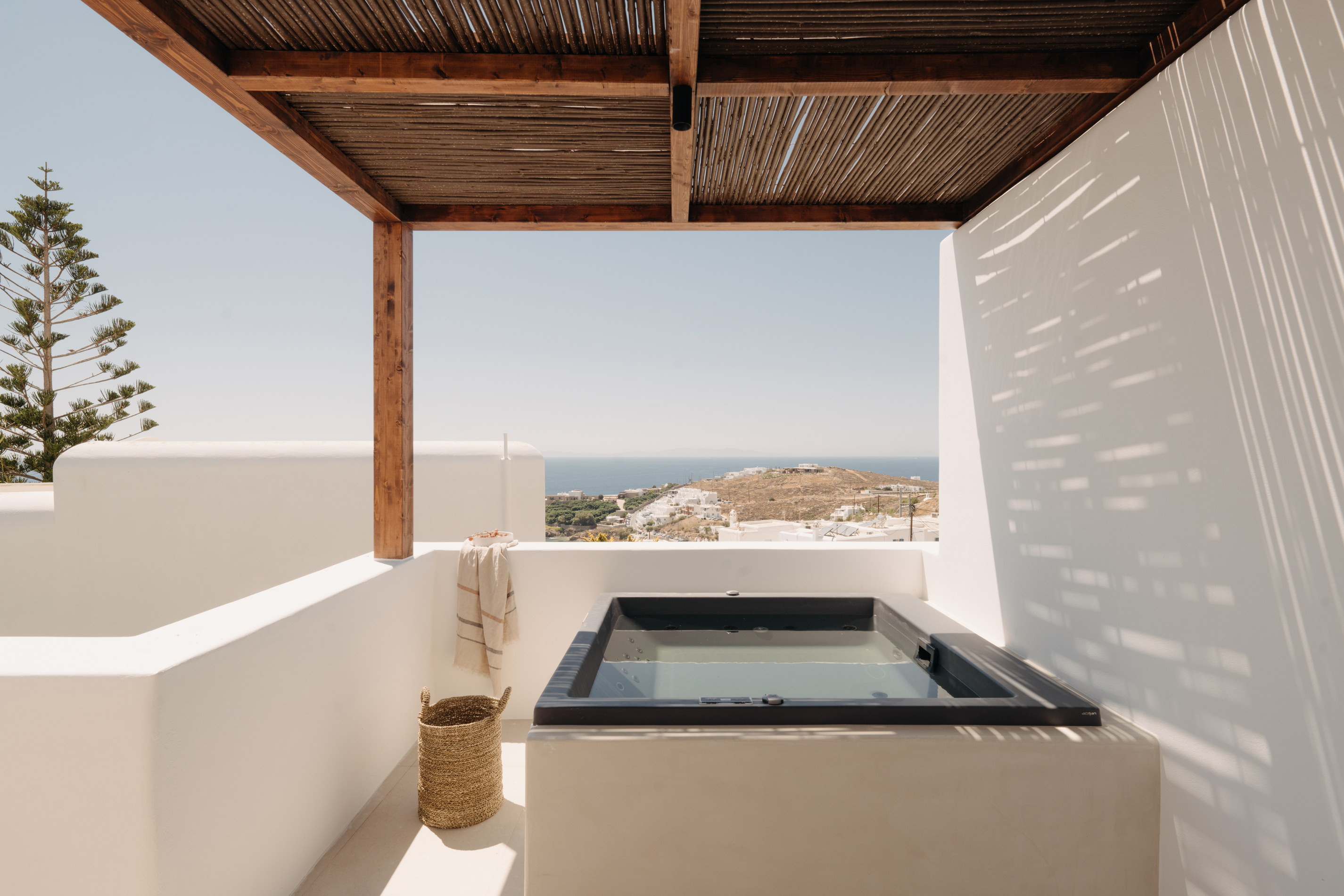 A private plunge pool and shaded pergola on a Bard de Sol suite terrace above Agios Stefanos